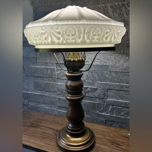 Milk glass table lamp with wood base.